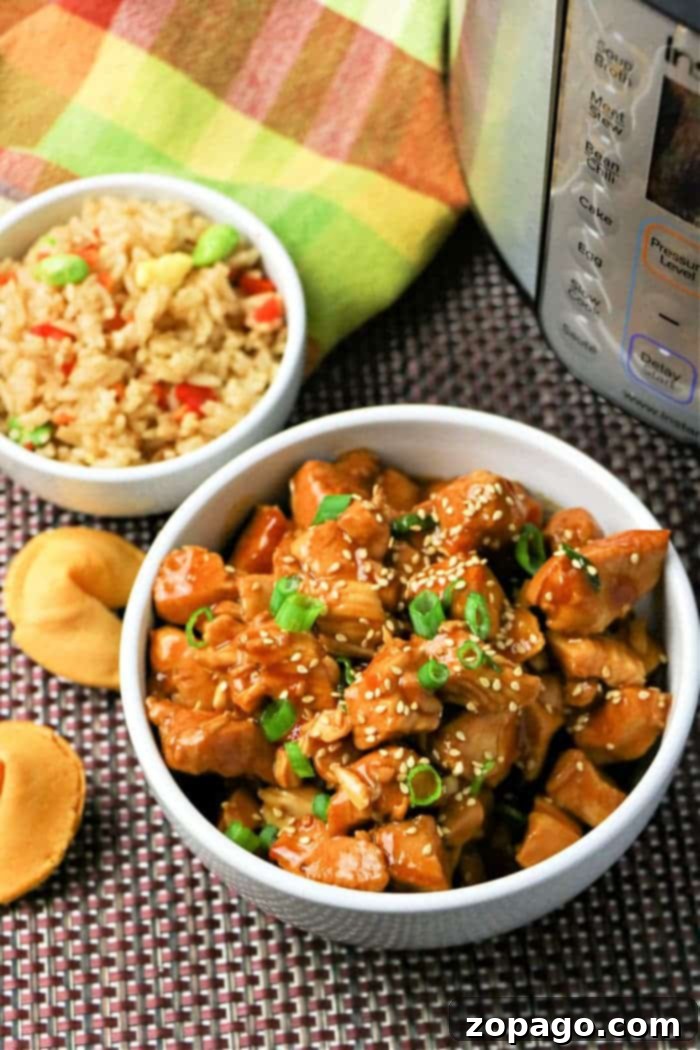 Flavorful Asian Chicken 10 A bowl of Instant Pot General Tso's Chicken, garnished and ready to eat.