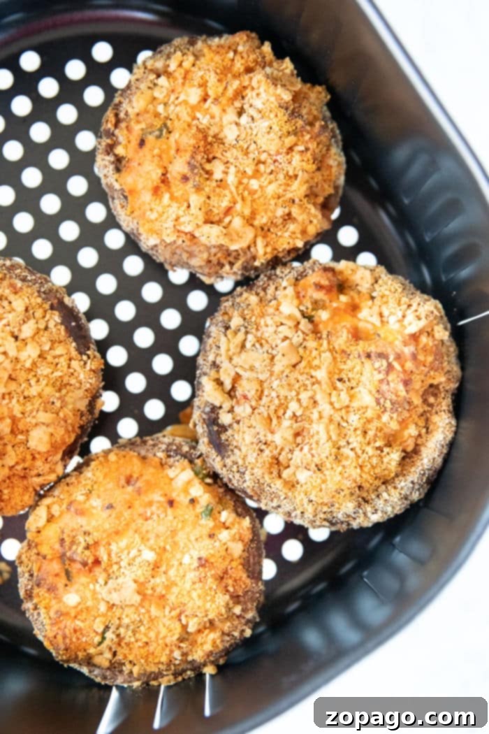 Effortless Air Fryer Stuffed Mushrooms 8 Ninja Foodi stuffed mushrooms, perfectly cooked and golden brown in the air fryer basket.