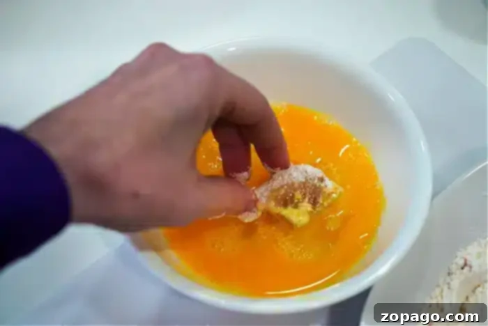Crispy cod nuggets cooking in an air fryer.