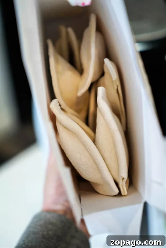 Crispy Air Fryer Frozen Pierogies 5 Ingredients for cooking frozen pierogies, including a box of pierogies, olive oil spray, salt, and pepper.