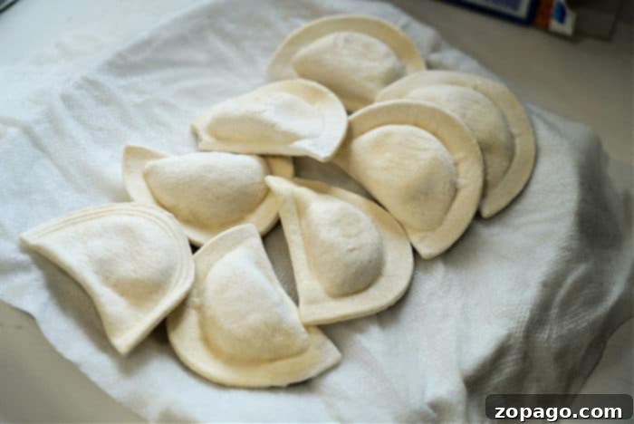 Crispy Air Fryer Frozen Pierogies 9 Microwave frozen pierogies wrapped in wet paper towels on a plate, pre-softening them before air frying.