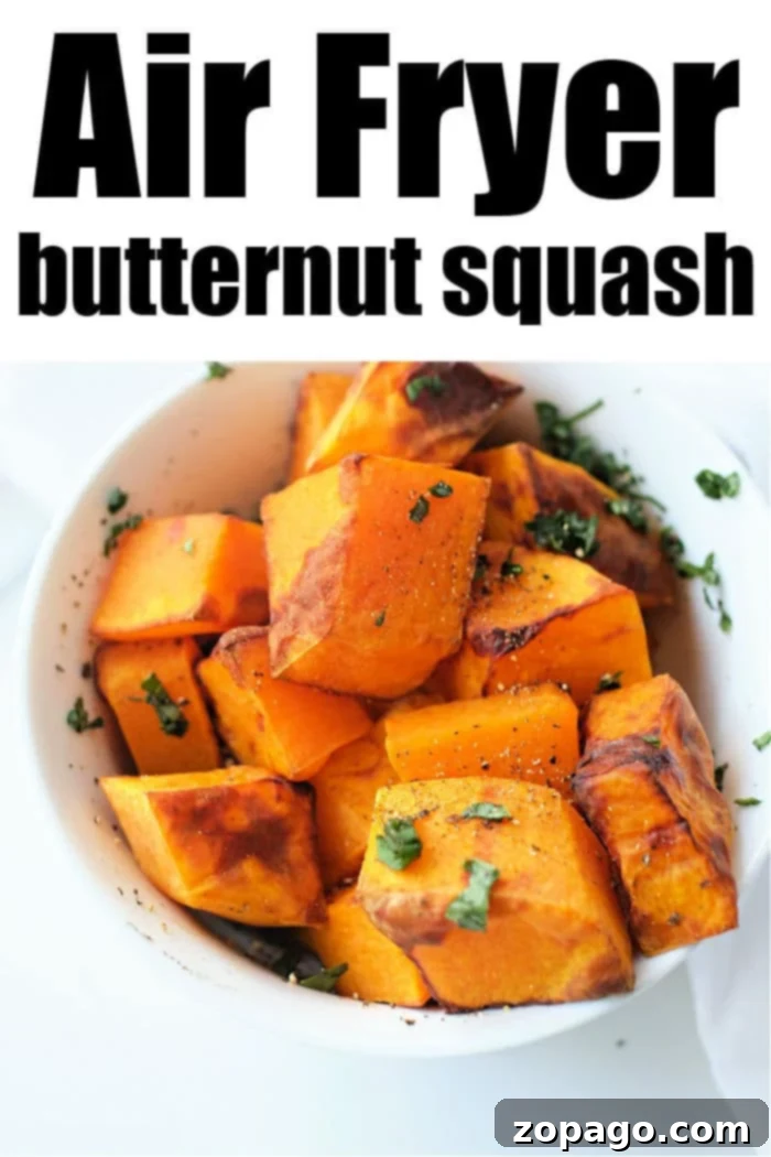 Crispy Air Fryer Butternut Squash 8 Close-up of golden-brown butternut squash cubes in an air fryer.