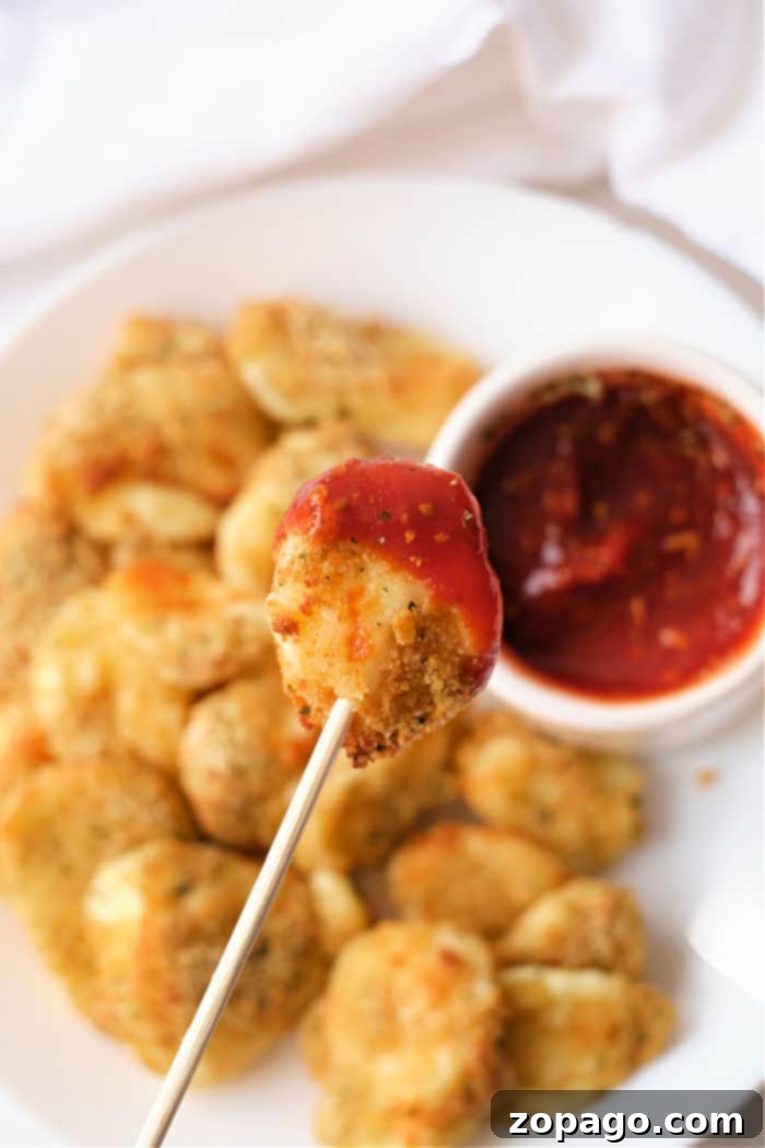 Perfectly Crispy Air Fryer Cheese Curds 2 Crispy golden-brown cheese curds cooked in an air fryer, ready to be served.