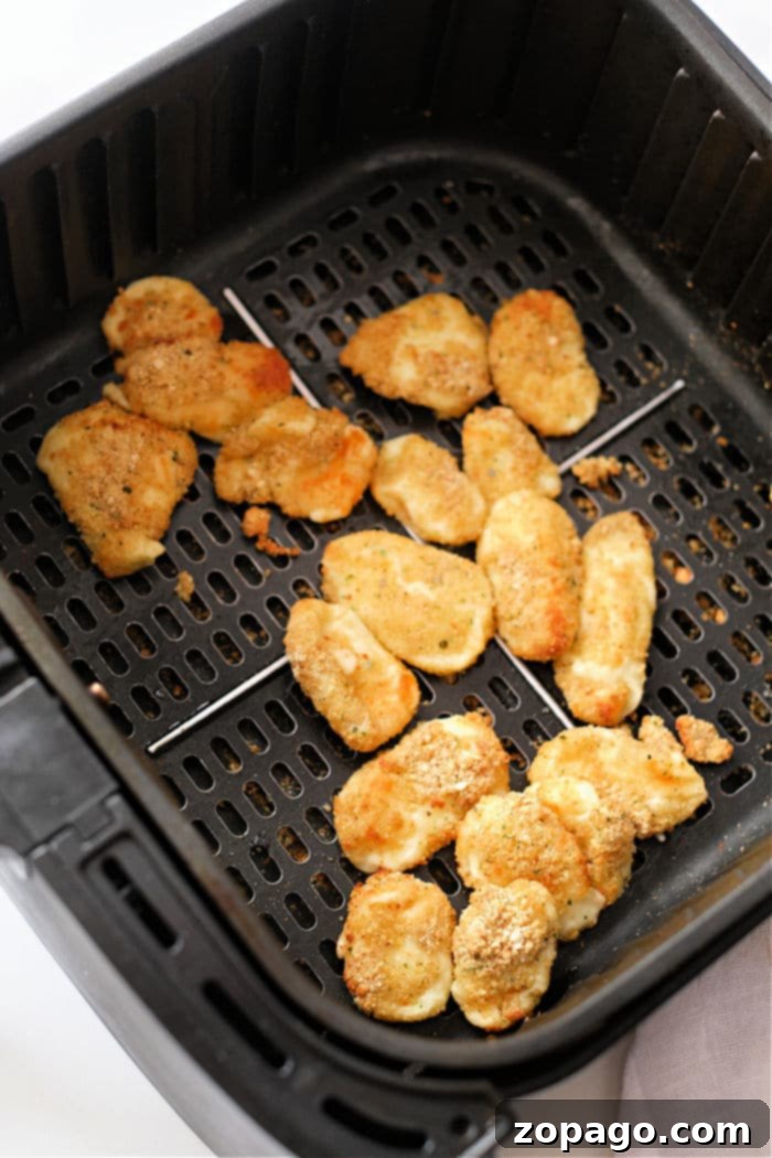 Perfectly Crispy Air Fryer Cheese Curds 7 Air fried cheese curds with a perfectly golden crust, ready to be eaten.