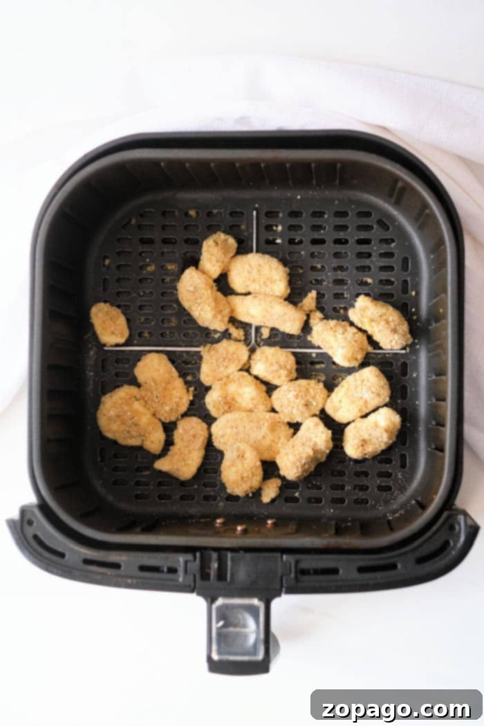 Perfectly Crispy Air Fryer Cheese Curds 9 A basket full of air fryer cheese curds, perfectly cooked and ready to serve.