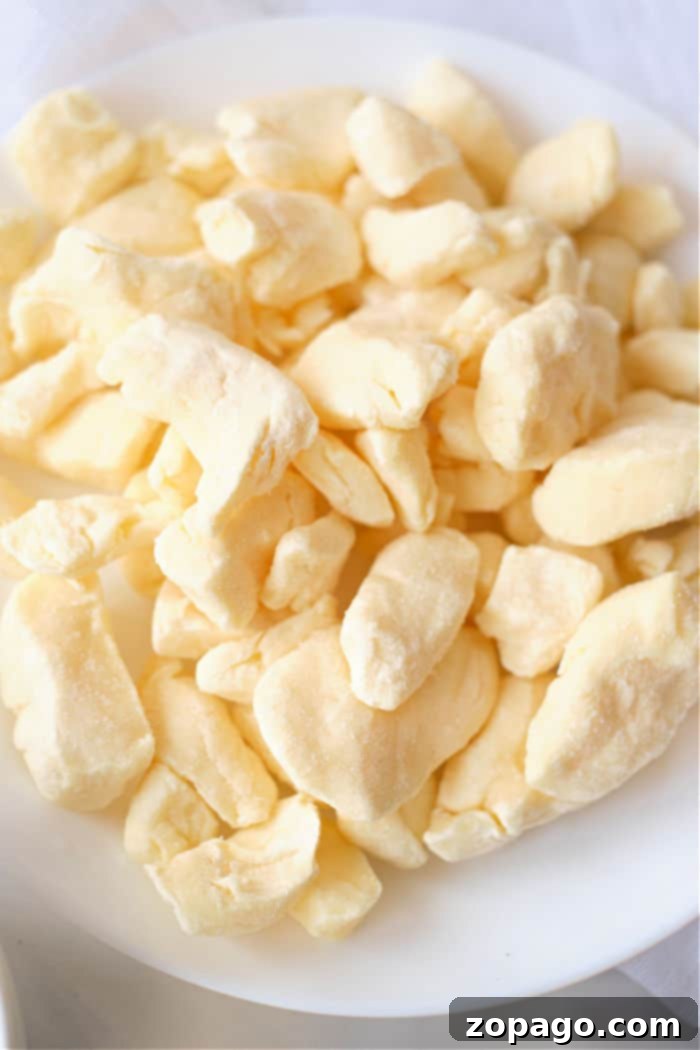 Cheese A Universe of Flavors 3 Golden-brown crispy air fryer cheese curds ready to be served.