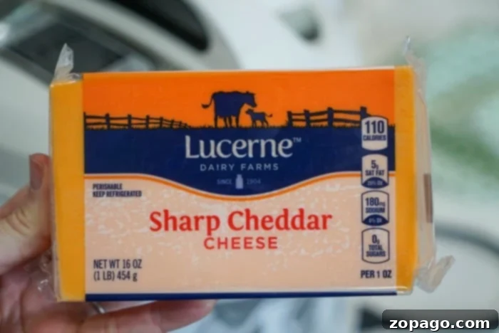 Cheese A Universe of Flavors 5 A block of sharp cheddar cheese with a crumbly texture.