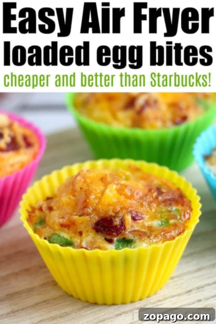 A World of Eggs 4 Colorful silicone cups holding air fryer egg bites with vegetables rest on a wooden surface.