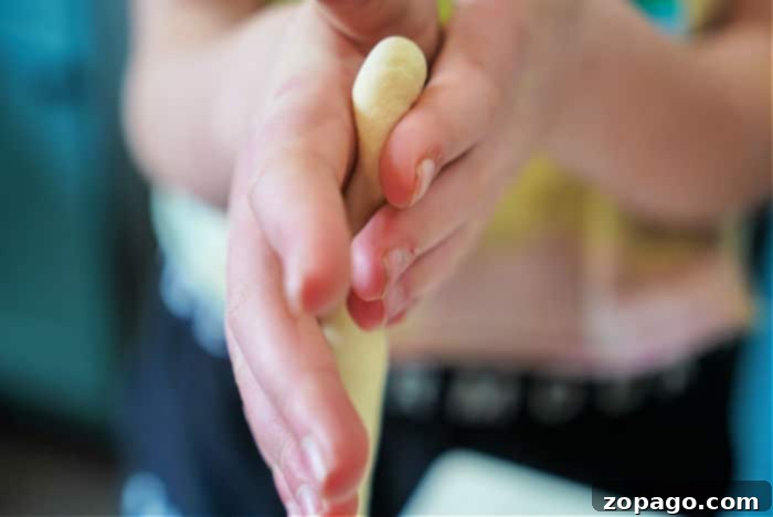Colorful Easter Loaf 5 Rolling thawed dough into snake-like strands for braiding