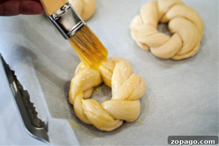 Colorful Easter Loaf 8 Applying egg wash to braided dough before baking