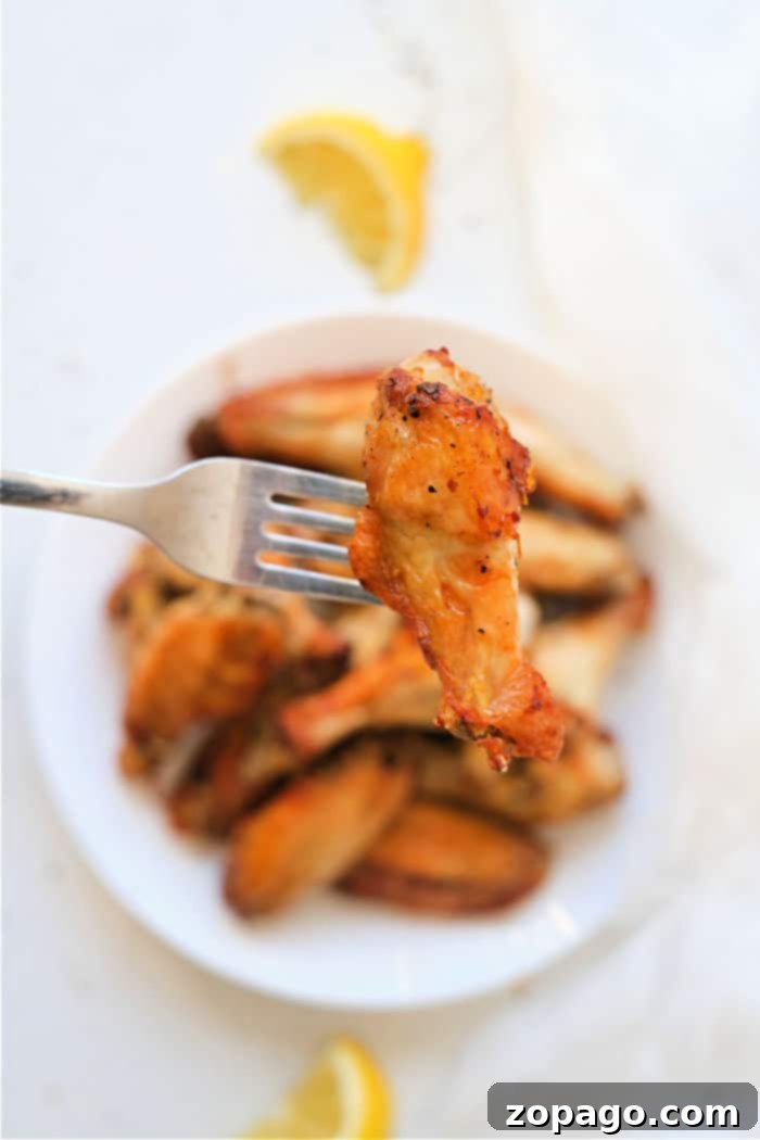 Crispy Air Fryer Lemon Pepper Wings 7 Air fryer filled with perfectly cooked lemon pepper chicken wings