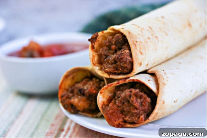 Crispy Air Fryer Flautas 10 A plate of golden brown Beef and Bean Taquitos, served with fresh salsa and sour cream, ready to be enjoyed.