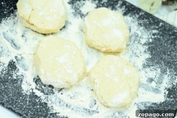 Golden Air Fryer Biscuits 5 Homemade biscuits in an air fryer basket.