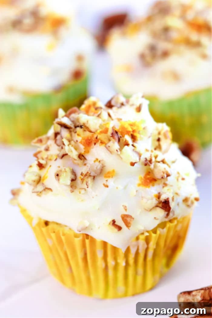 Zucchini Carrot Morning Glory Muffins 10 A delightful carrot muffin with cream cheese frosting, sprinkled with chopped nuts, all nestled in a vibrant yellow wrapper. Inspired by the warmth of zucchini carrot muffins, it balances sweetness and texture perfectly.