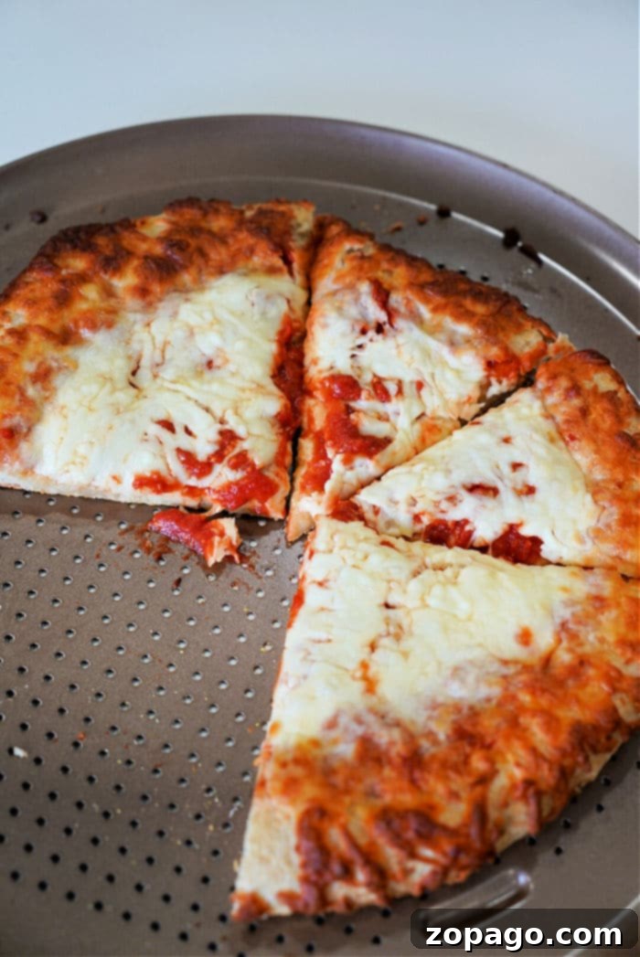 Air Fryer Pizza Reheat: Crispy Perfection 5 Reheat Pizza in Air Fryer Crispy - A close-up shot of a perfectly reheated pepperoni pizza slice, showcasing a golden-brown crispy crust and bubbling, melted cheese. The background is softly blurred, highlighting the delicious texture of the pizza.