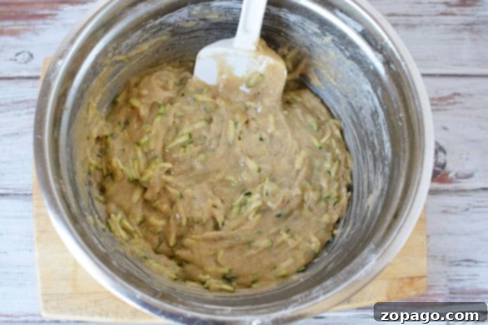 Crispy Air Fryer Zucchini Loaf 5 Freshly baked air fryer zucchini bread, golden and ready to serve on a cutting board.