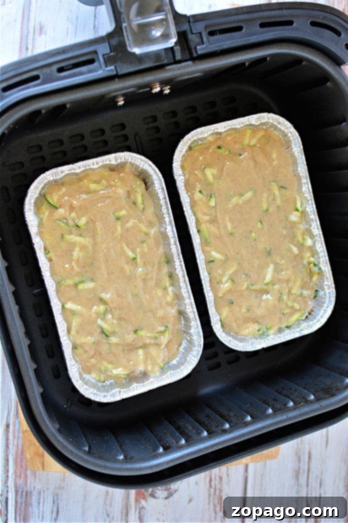 Crispy Air Fryer Zucchini Loaf 6 A perfectly baked mini zucchini bread loaf, golden brown and enticing, ready to be enjoyed.