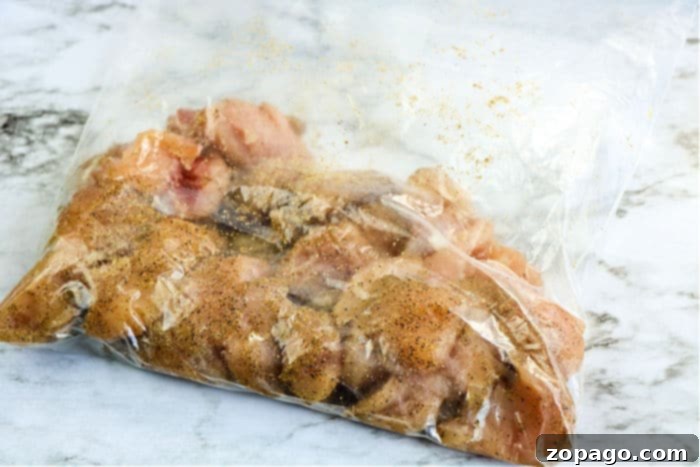 Chicken pieces marinating in a bag with spices, ready for cooking.