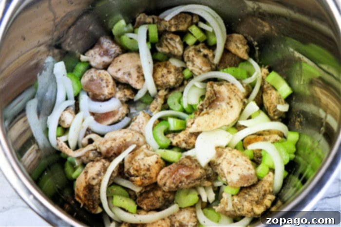 Bold Black Pepper Chicken 5 Pressure cooker pot with black pepper chicken and vegetables, ready to be cooked.