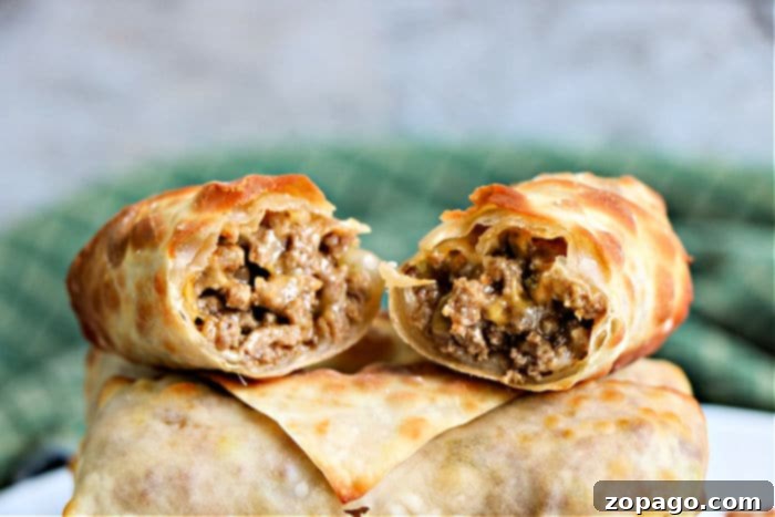 Crispy Beef Egg Rolls 10 Air Fryer Cheeseburger Egg Roll recipe served with a variety of dipping sauces on a wooden board