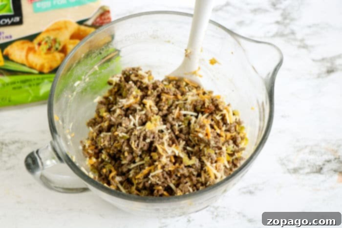 Crispy Beef Egg Rolls 5 Delicious ground beef egg roll filling prepared in a bowl, with ingredients mixed together