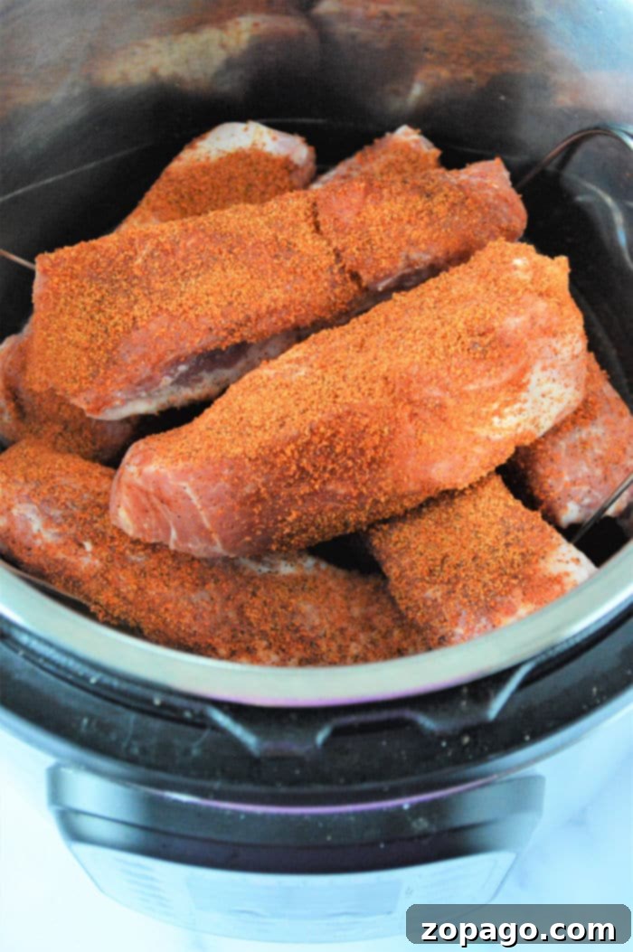 Instant Pot Country Style Pork Ribs 5 pressure cooker country style ribs - Ribs stacked on a trivet inside an Instant Pot.