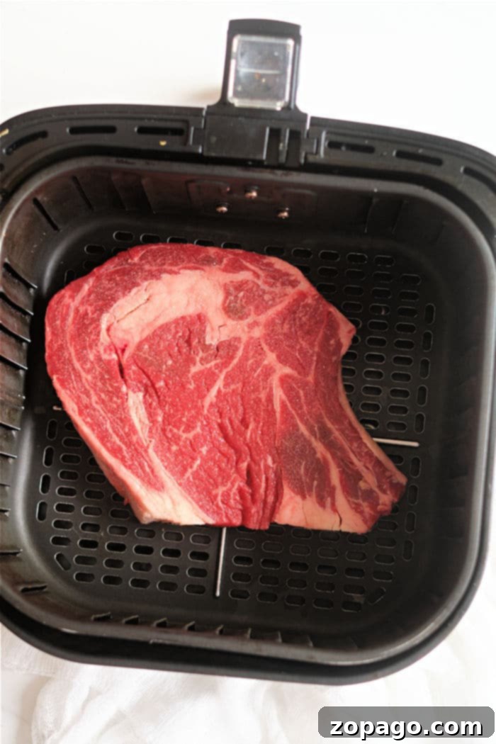 Perfect Air Fryer Ribeye 4 Air fryer ribeye steak beautifully seasoned and ready for cooking.