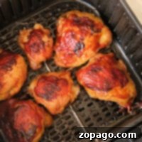 Air fryer frozen chicken thighs come out browned and crispy, with a beautifully glazed appearance that rivals any fresh preparation.
