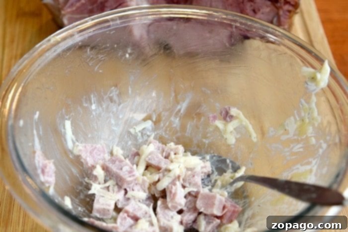Here is the best leftover ham recipe you will ever make, and your kids will absolutely love it! Use your ham leftovers after the holidays to make these cheesy crescent roll ham turnovers or roll-ups that are a great lunch or dinner idea. #ham #leftover #recipe #easy #best #muffintin leftover ham recipe, showing delicious, golden brown crescent roll turnovers fresh out of the oven.