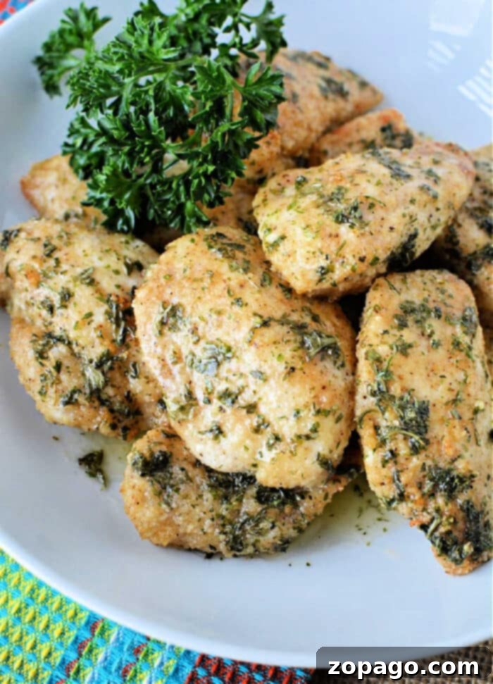 Crispy Air Fryer Boneless Wings 2 Crispy Air-Fryer Boneless Wings served with dipping sauce, garnished with fresh herbs, showcasing a healthy meal.