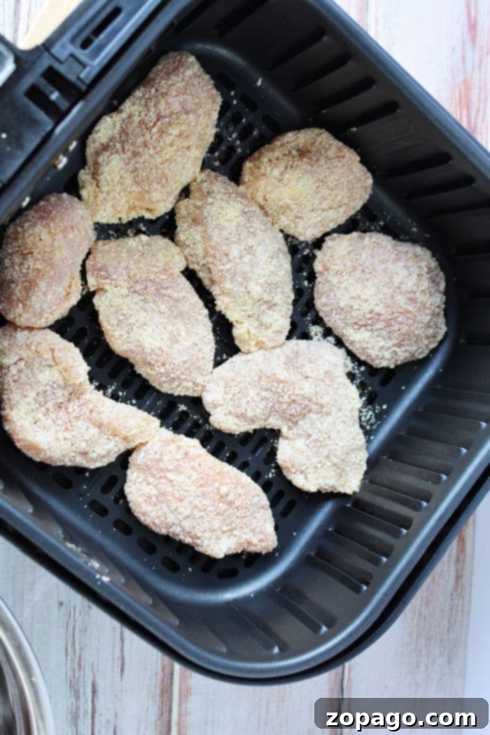 Crispy Air-Fried Chicken Bites 6 A vibrant plate of air fryer boneless chicken wings with fresh parsley