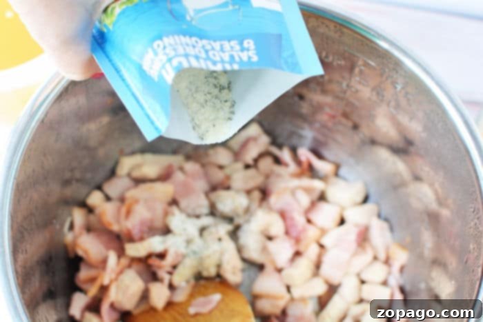 Creamy Chicken Comfort Soup 4 Diced chicken and bacon being sautéed in a pot