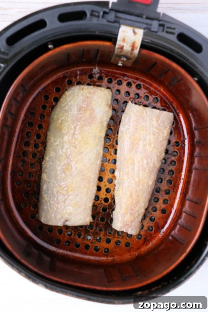 Easy Air Fryer Mahi Mahi 5 Perfectly air-fried mahi mahi fillets presented in the air fryer basket.