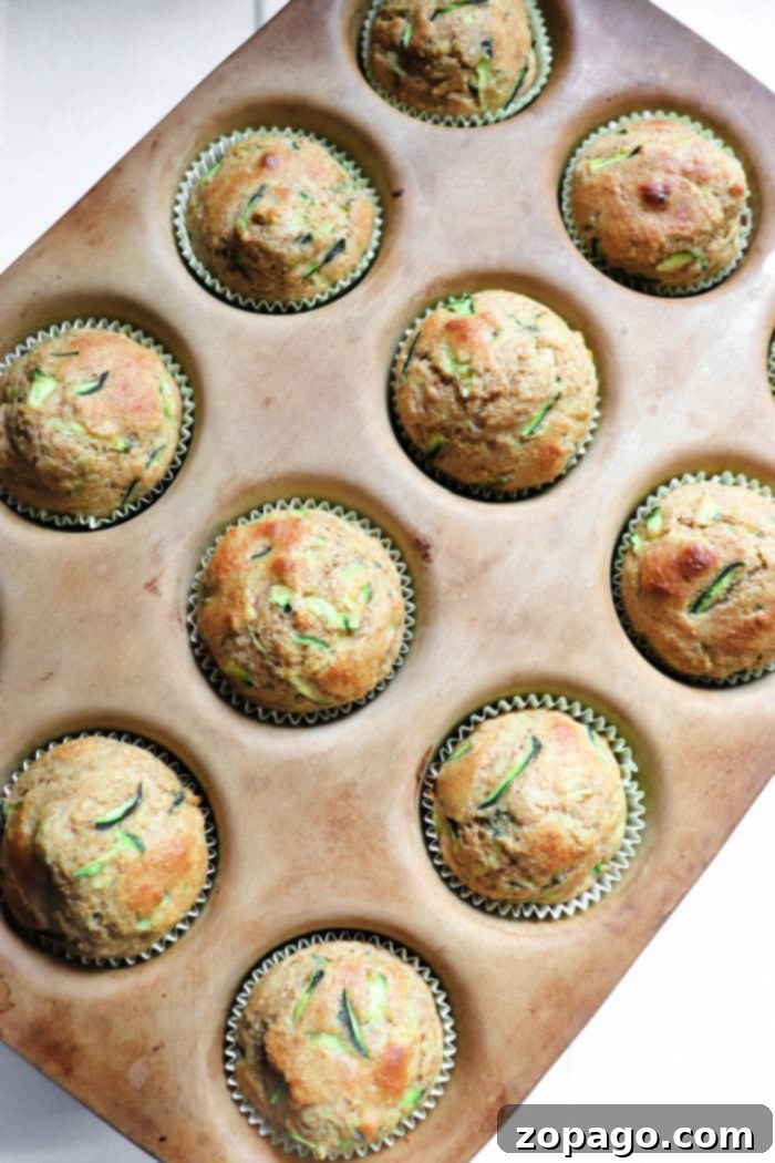 Wholesome Zucchini Applesauce Muffins 10 A large platter filled with easy zucchini muffins, some with a dusting of powdered sugar, making them look irresistible.