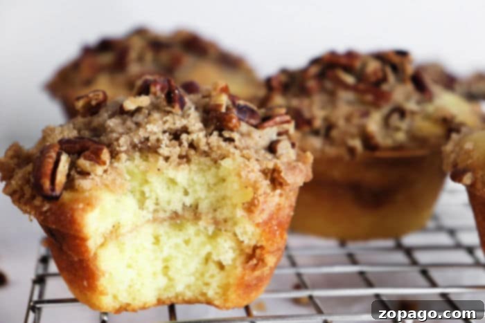 Ultimate Bakery Coffee Cake Muffins 11 Perfectly golden cinnamon muffins cooling on a wire rack, with steam gently rising.
