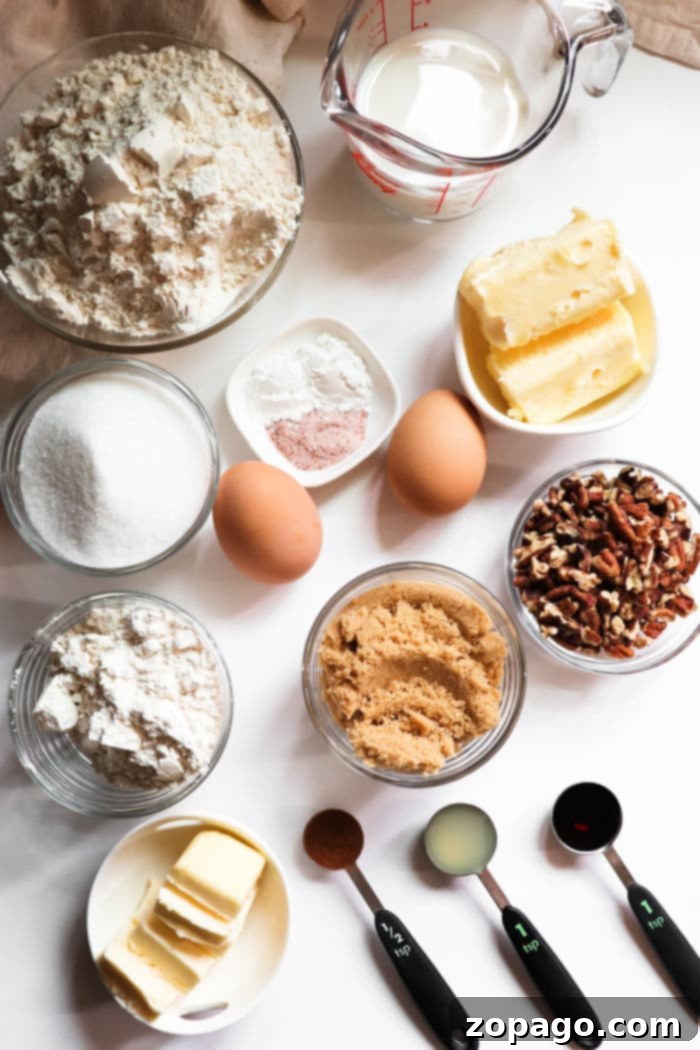 Ultimate Bakery Coffee Cake Muffins 5 Various baking ingredients including flour, sugar, eggs, and butter, neatly arranged on a countertop.