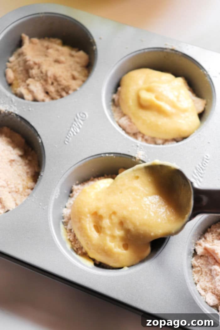Golden-brown cinnamon sugar muffins on a cooling rack, freshly baked.