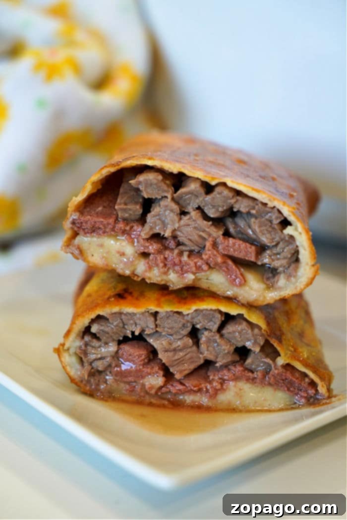 Air Fryer Beef Wellington Puffs 2 Golden brown Air Fryer Beef Wellington hot pocket, showing the crispy dough and a hint of filling.