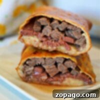 Deconstructed Air Fryer Beef Wellington, cut in half to show the layers of beef and pate.