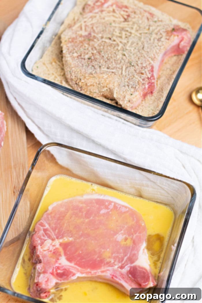 Crispy Air Fryer Pork Chops 5 Close-up of breaded pork chops neatly arranged in an air fryer basket, ready for cooking to golden perfection.