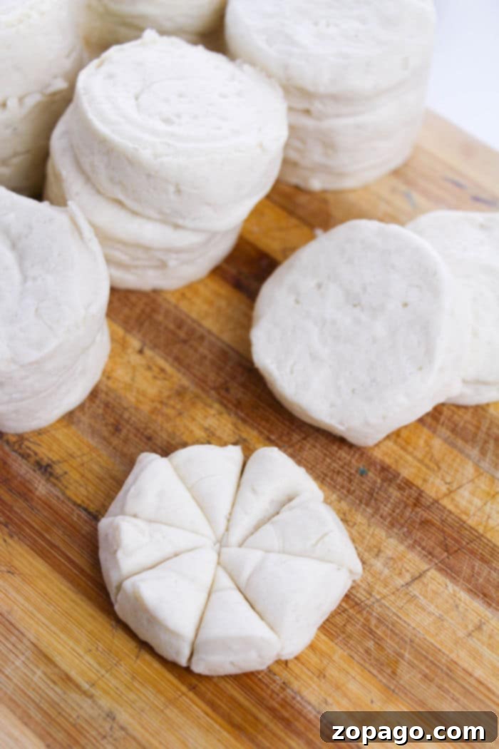 Biscuit Monkey Bread Muffins 4 Uncooked biscuit dough, perfectly sliced into eight pieces, ready for making monkey bread.