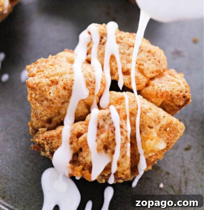 Biscuit Monkey Bread Muffins 7 A delicious stack of Monkey Bread Cupcakes, drizzled with glaze and ready to be enjoyed.
