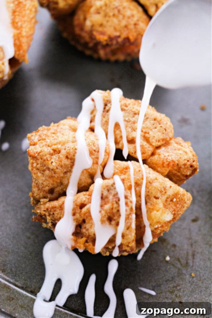 Biscuit Monkey Bread Muffins 9 Individual monkey bread muffins artfully arranged on a rustic wooden surface, highlighting their homemade charm.