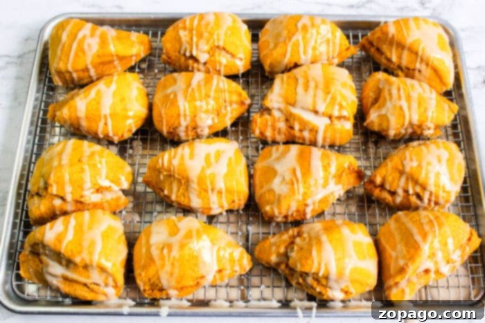 A warm, inviting close-up of a single homemade pumpkin scone, highlighting its beautiful texture and the rich pumpkin color.