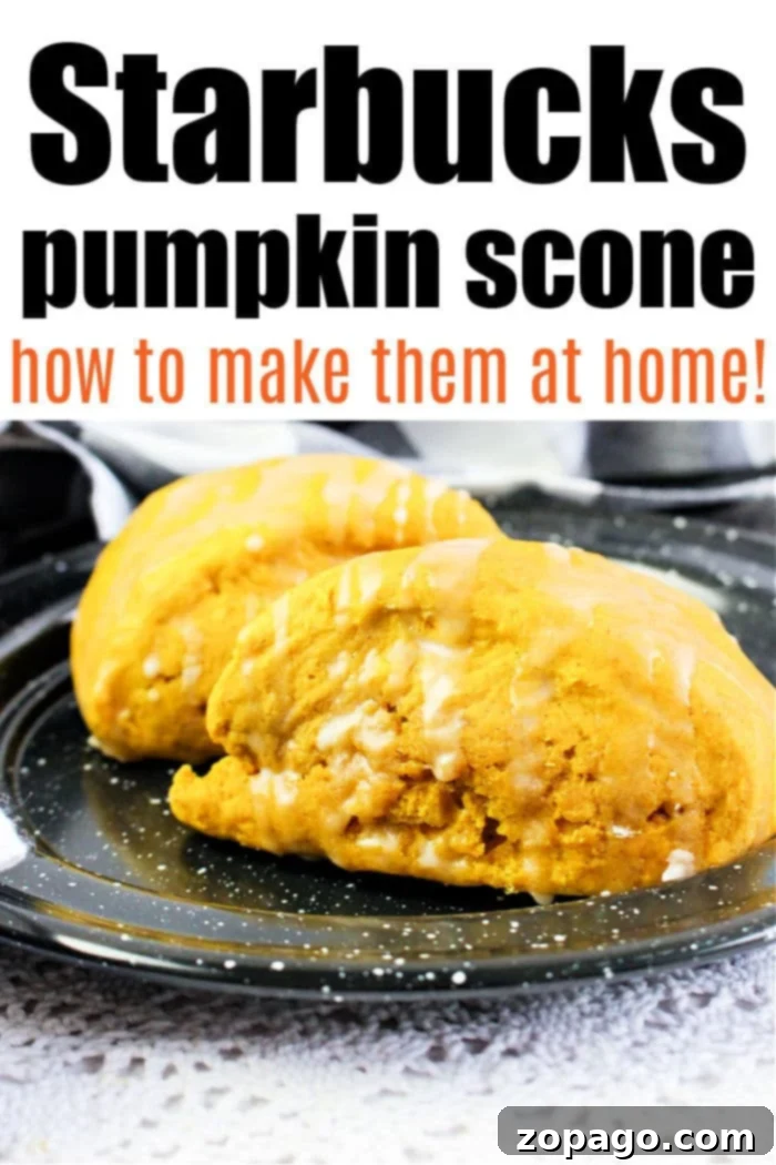 Two Starbucks-style pumpkin scones, richly glazed, are perfectly arranged on a cooling rack, tempting with their delicious aroma.