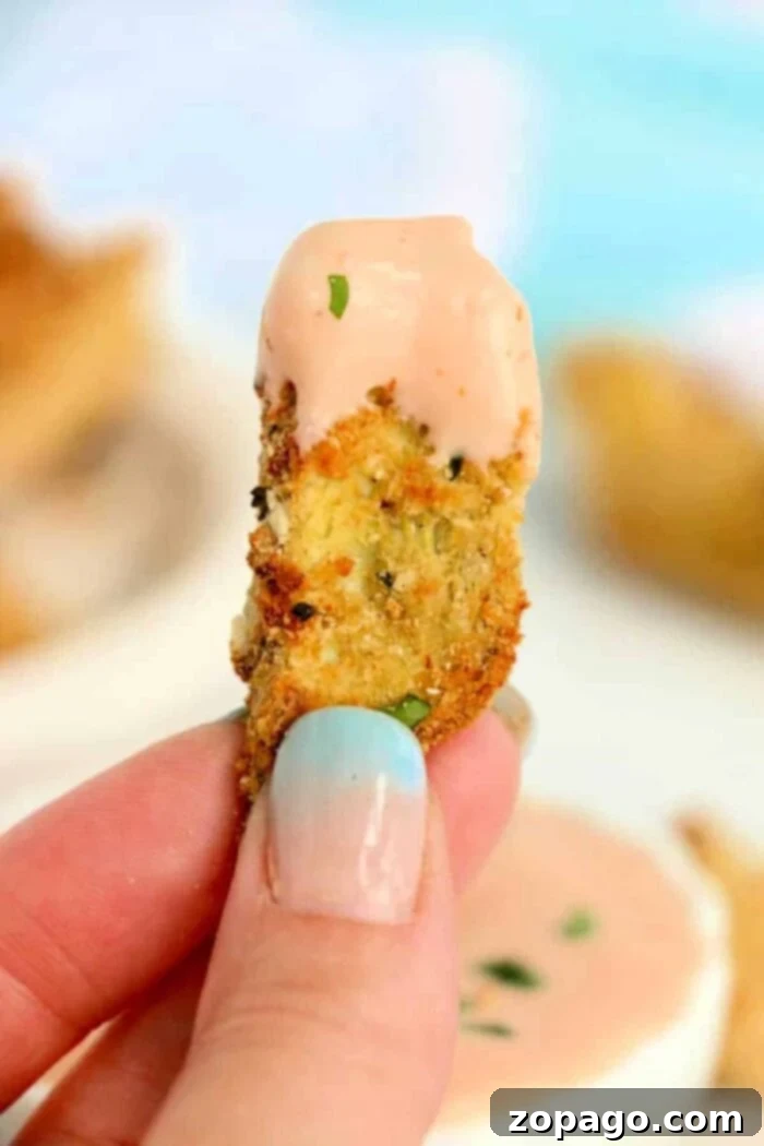 A top-down view of a bowl filled with air fryer artichoke hearts, perfect for a party snack.