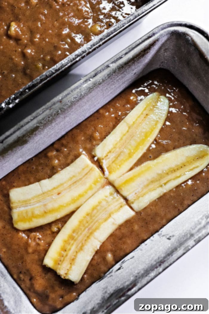 Warm Ginger Banana Bread 5 Close-up of a gingerbread banana bread slice, showcasing its moist texture and the decorative banana topping.
