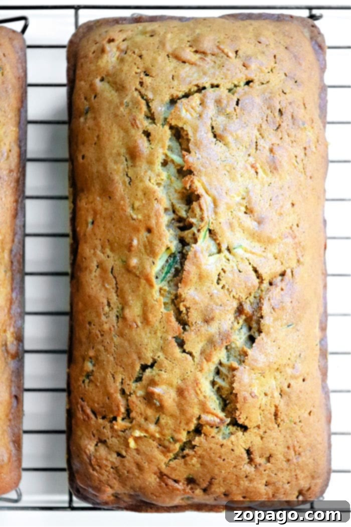 Spiced Zucchini Gingerbread Delight 2 Delicious Zucchini Gingerbread Loaf cooling on a rack, ready to be sliced