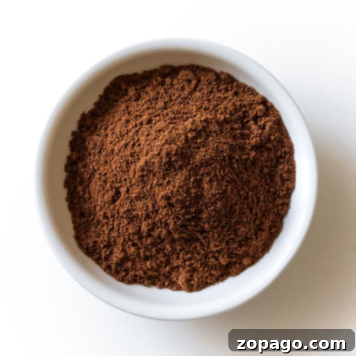 Close-up of ground allspice powder, adding a complex warm note to gingerbread spice.
