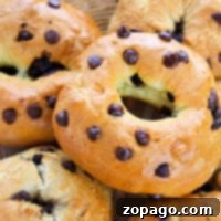 A basket of chocolate chip bagels, golden brown with a shiny glaze, crafted using the 2-Ingredient Bagels recipe.